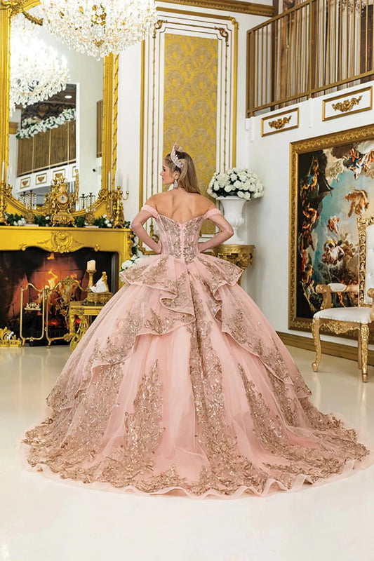 Back view of rose gold quinceañera ball gown featuring a structured lace-up corset back, cascading layered ruffles, and intricate lace detailing in an elegant gold interior.