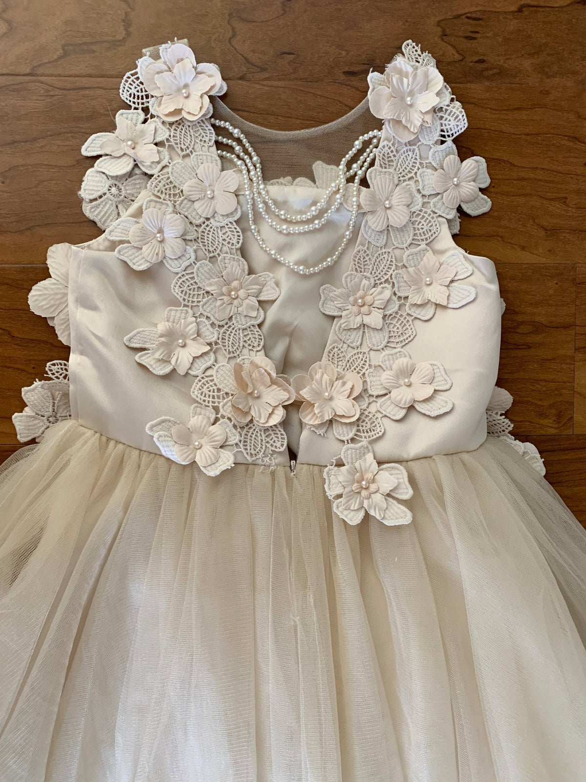 Bodice close-up highlights champagne High-Low Tulle flower girl dress with 3D Flower Lace Top Accentuated with Pearl Trim Dress.