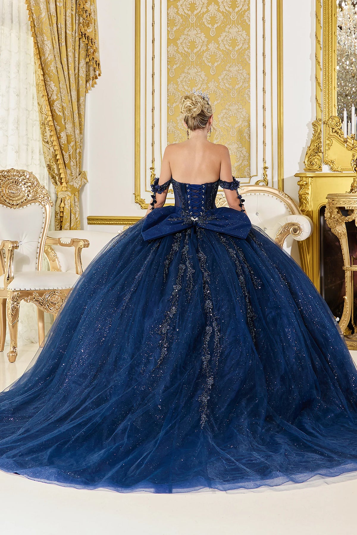 Back view of a Navy quinceañera gown showing lace-up back and 3D floral appliqués