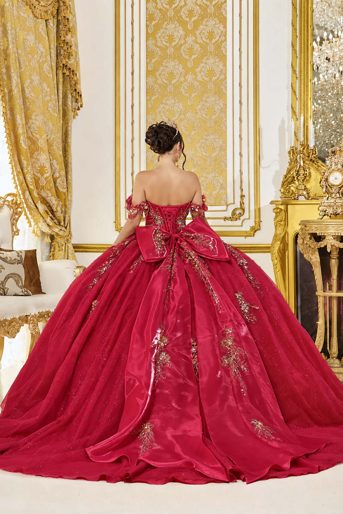 Revealing corset lacing above its embroidered train, this Burgundy quinceañera ball gown is shown from the back.