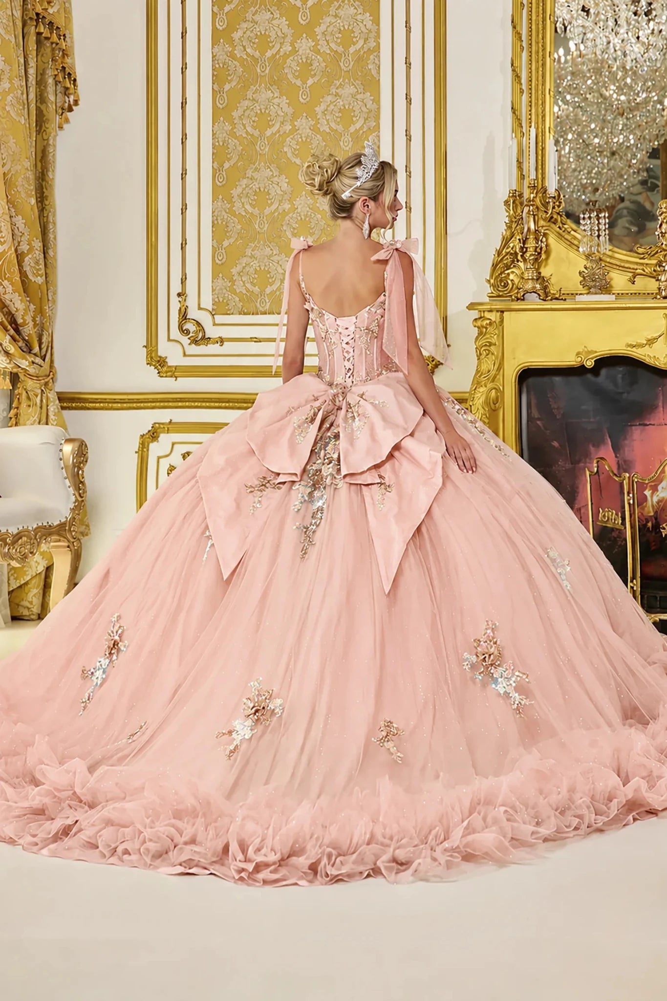 Blush quinceanera ball gown with lace-up corset and oversized back bow