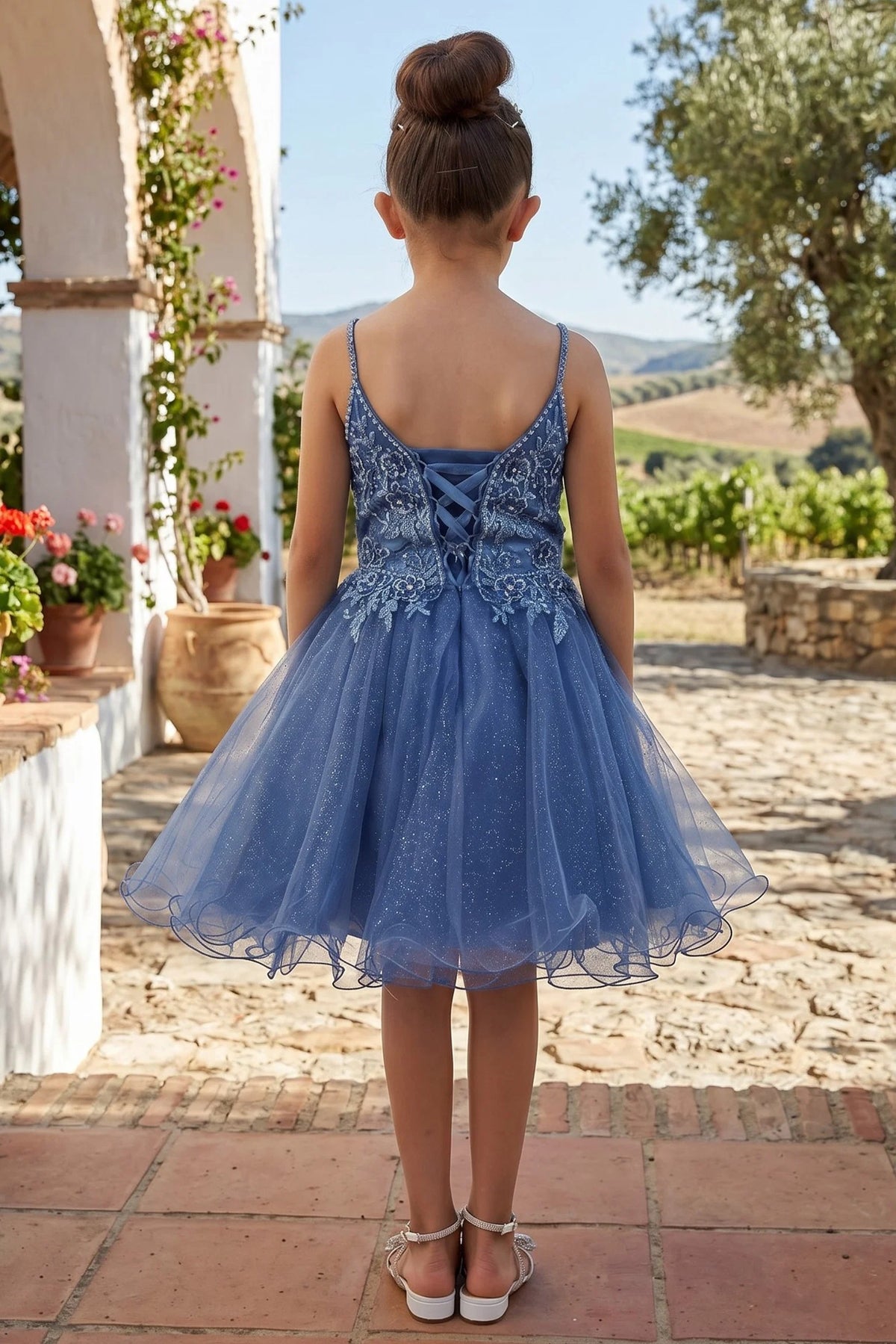 Lace-up fastening shapes the back of the Smoky Blue kids party dress.