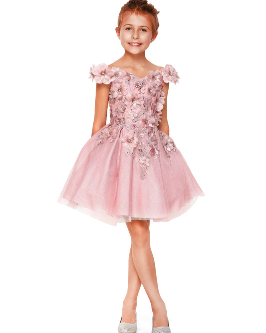 Young girl wearing a dusty rose floral dress on a white background