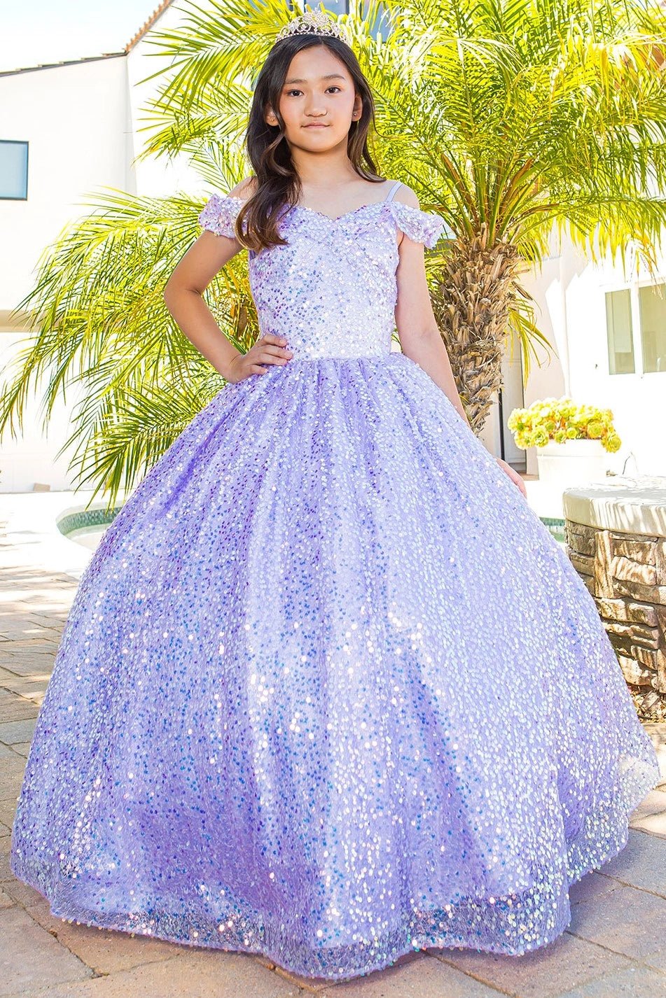 Shown in a front view, the Lilac mini quince dress has off-shoulder sleeves and an allover sequin ball skirt.