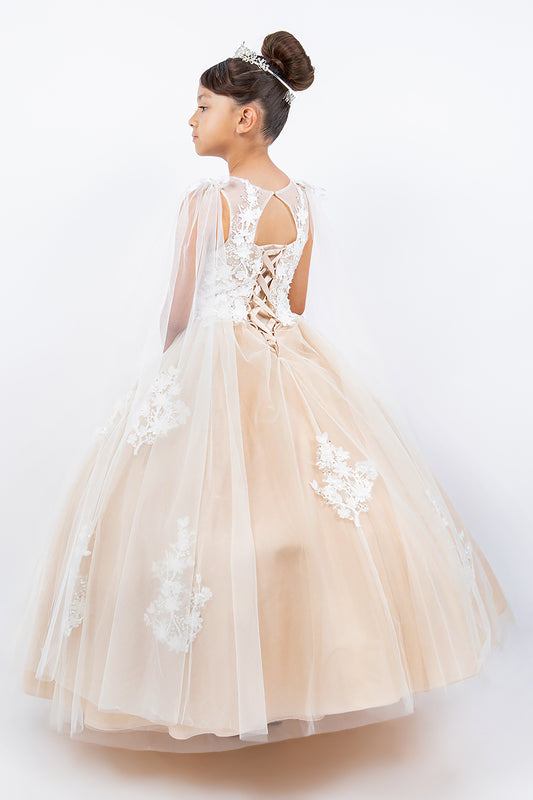 Young girl wearing a champagne and white floral dress on a white background