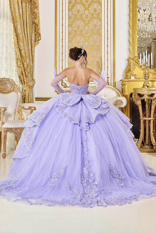 Woman in a lavender gown with floral details in an opulent room.