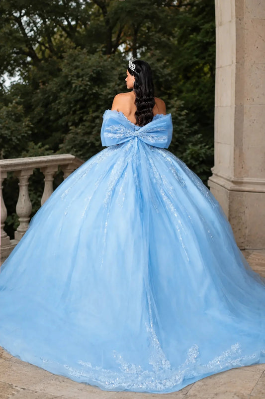 Back view of a woman in a bahama blue quinceañera ball gown featuring lace-up corset Back with big Back bow