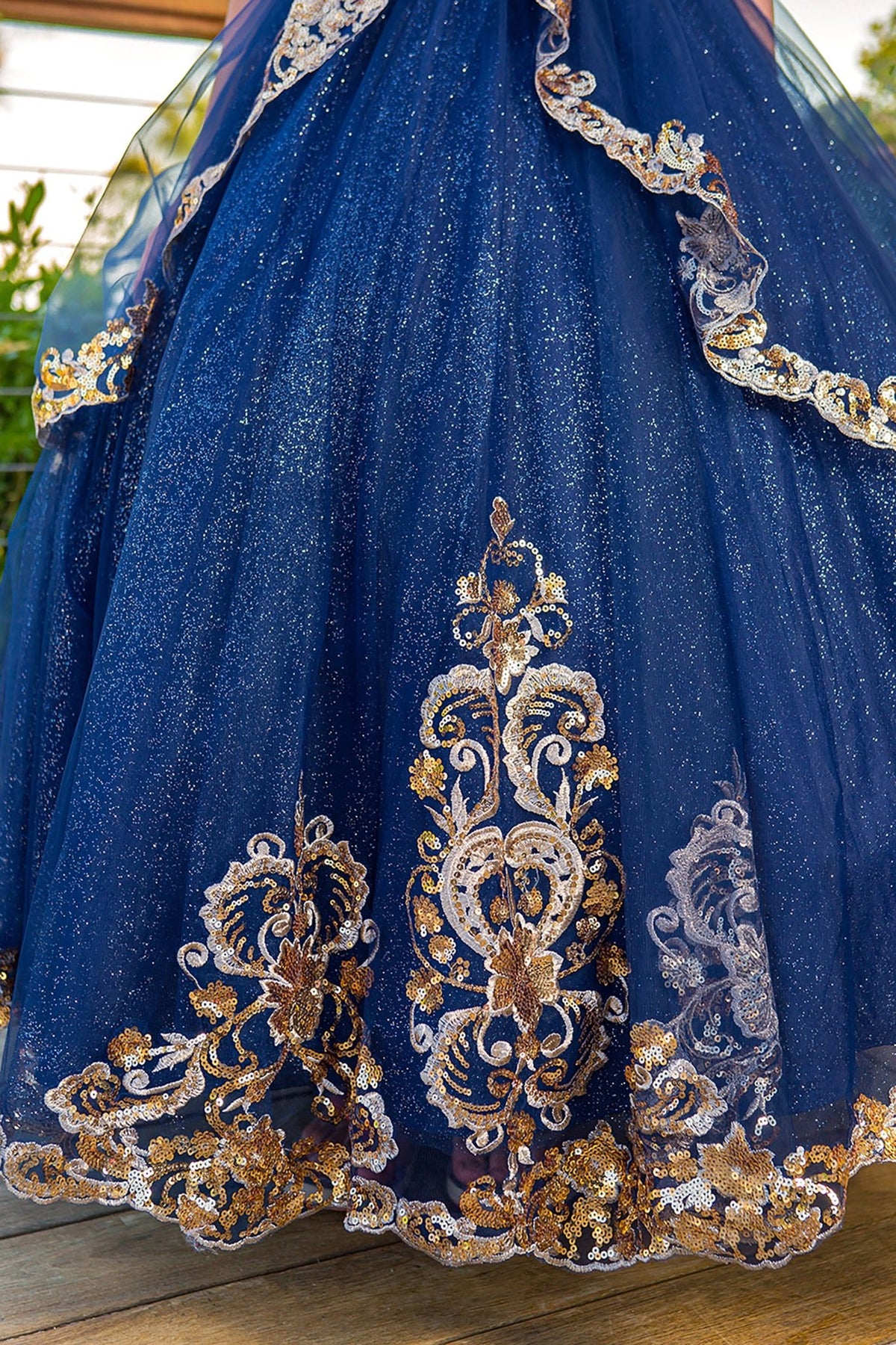 Close-up of navy mini quince dress with glittered two-tone lace satin tulle skirt detailing