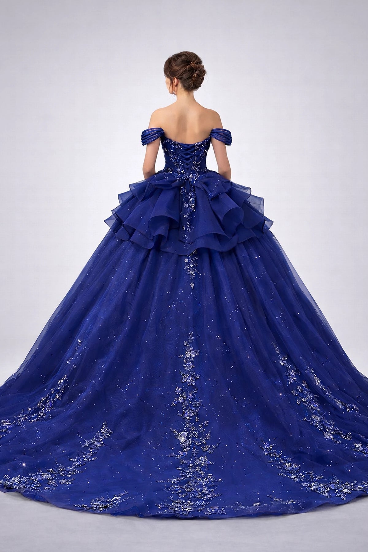 From the back, the Navy quinceañera ball gown reveals its floor-length skirt.