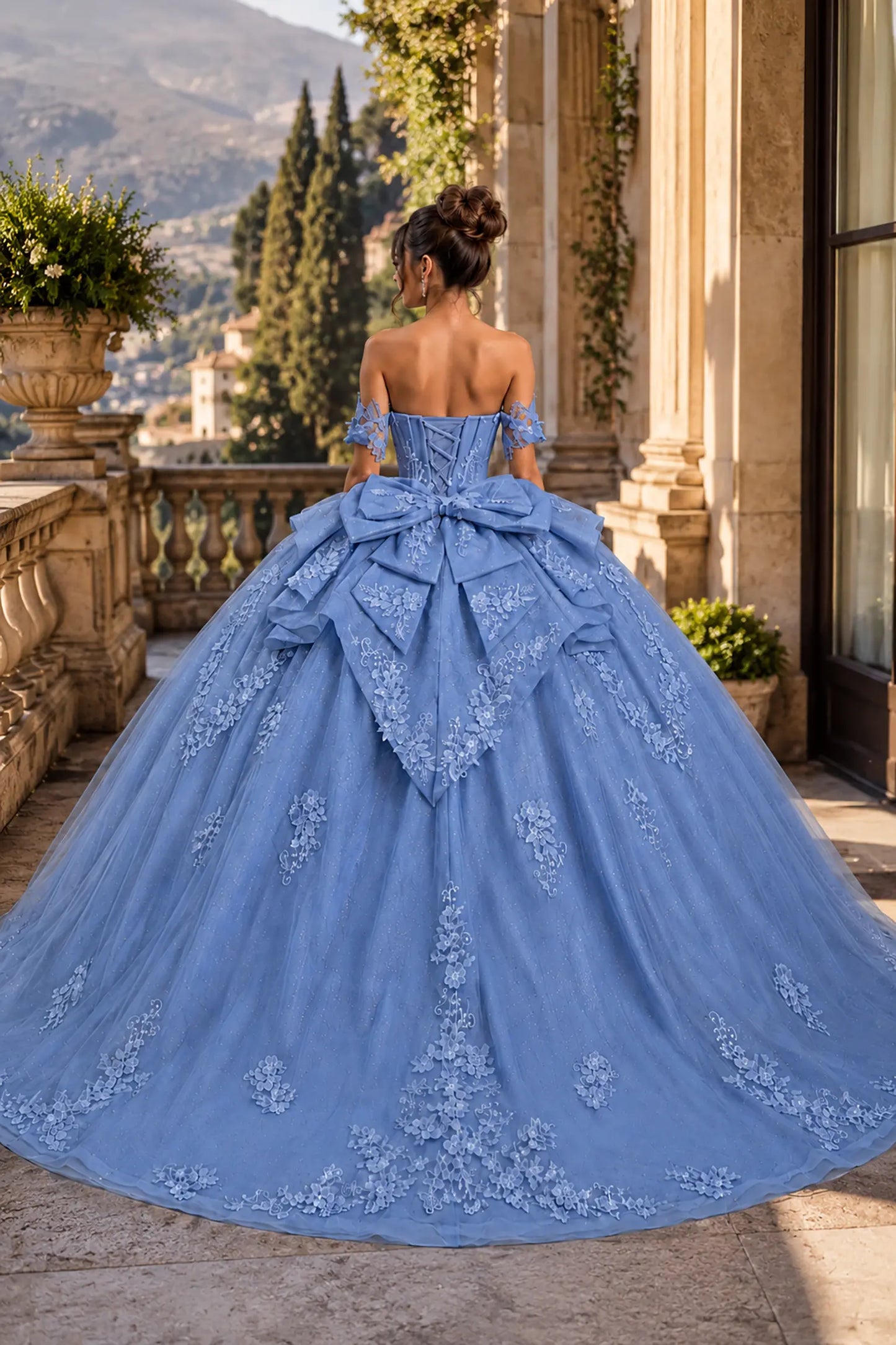 soft blue quinceanera ball gown with lace-up corset back, oversized bow, tiered overskirt, and chapel-length train