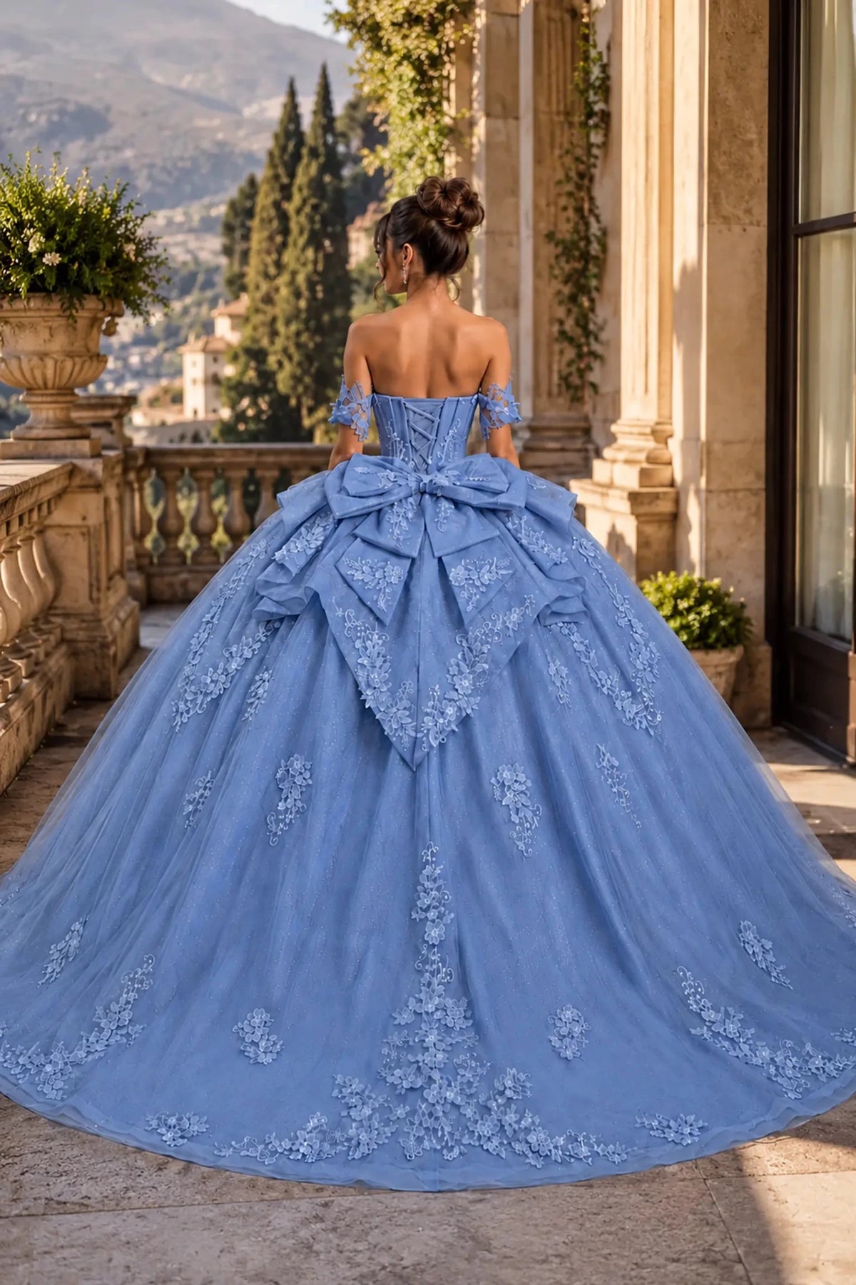 soft blue quinceanera ball gown with lace-up corset back, oversized bow, tiered overskirt, and chapel-length train