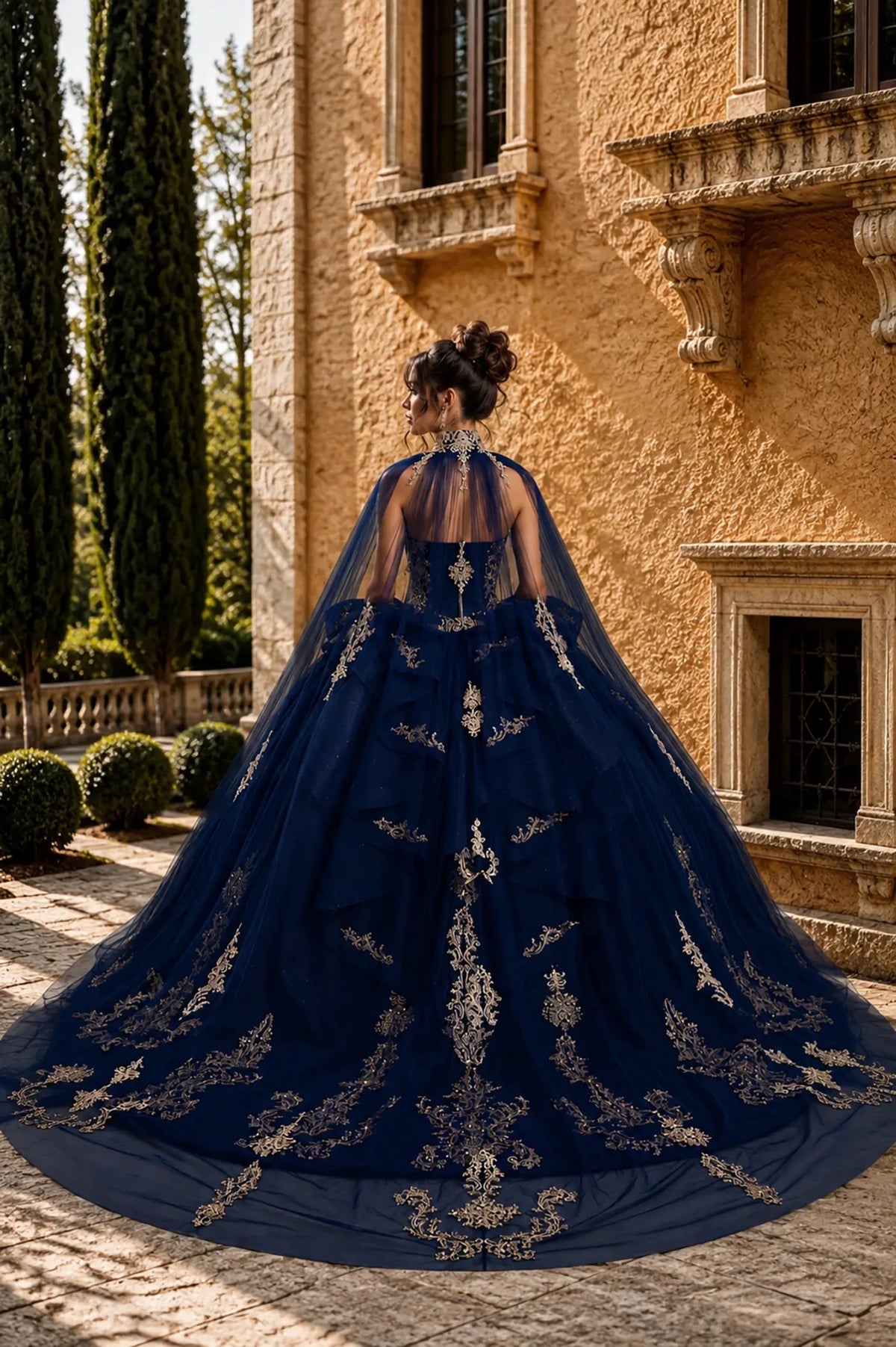 navy quinceanera ball gown with lace-up corset back, detachable cape, gold embroidery, and chapel-length train