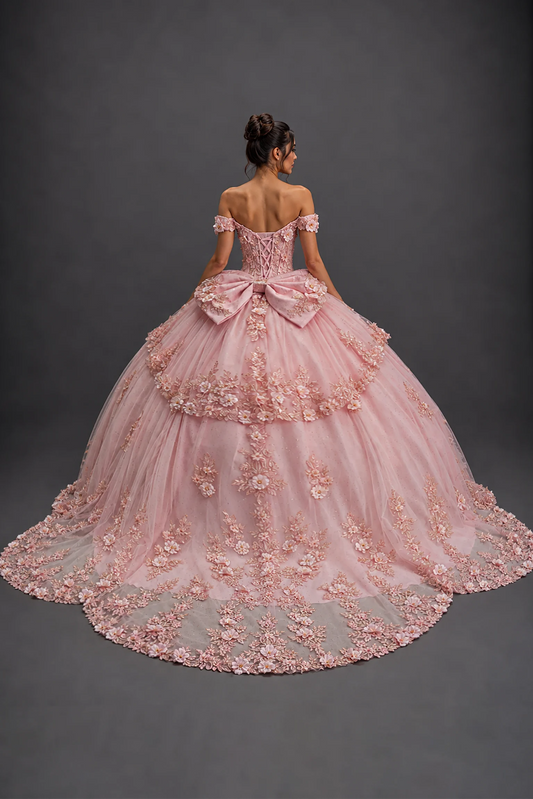 Back view of blush quinceañera dress with lace-up corset, bow, 3D florals and train