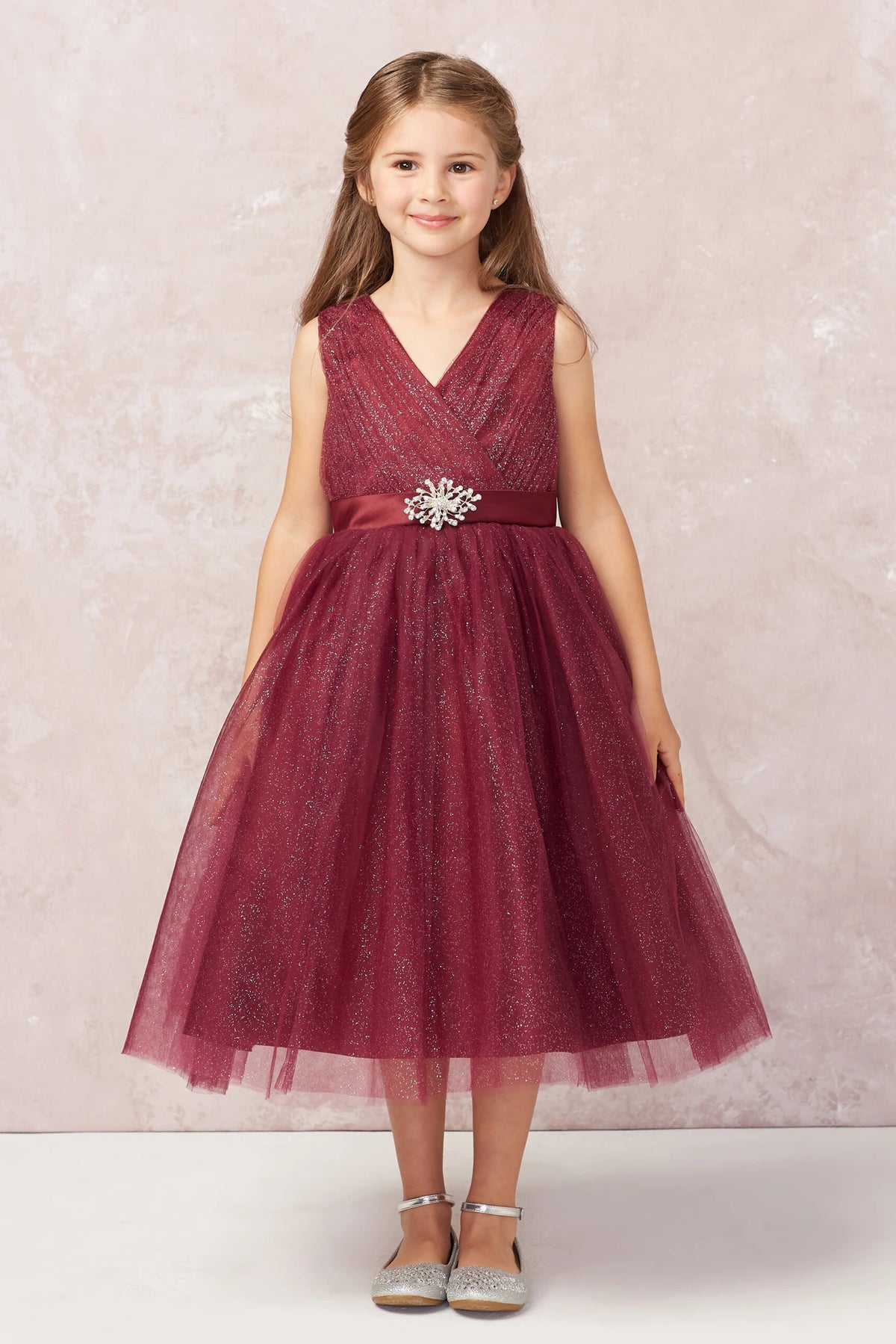 Burgundy kids pageant dress featuring a ruched V-neckline and rhinestone brooch.