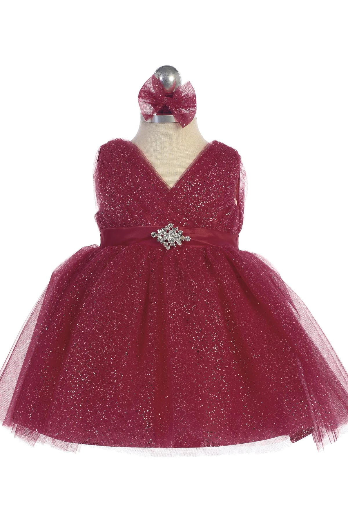 The Burgundy kids pageant dress has a ruched V-neckline and rhinestone brooch.