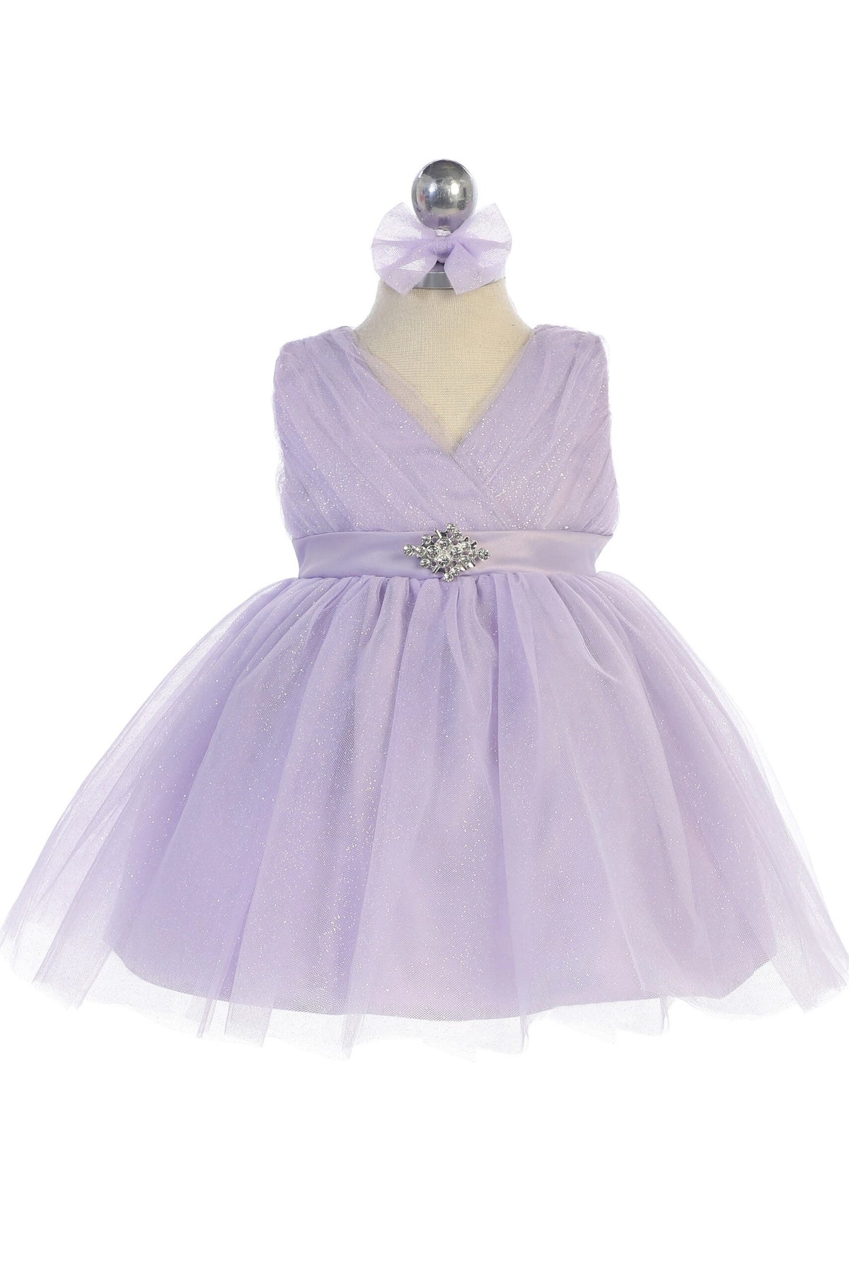 The Lilac kids pageant dress has a ruched V-neckline and rhinestone brooch.