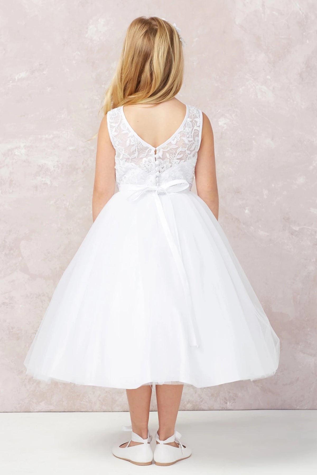 Defined by V-shaped lace back, this white flower girl dress.