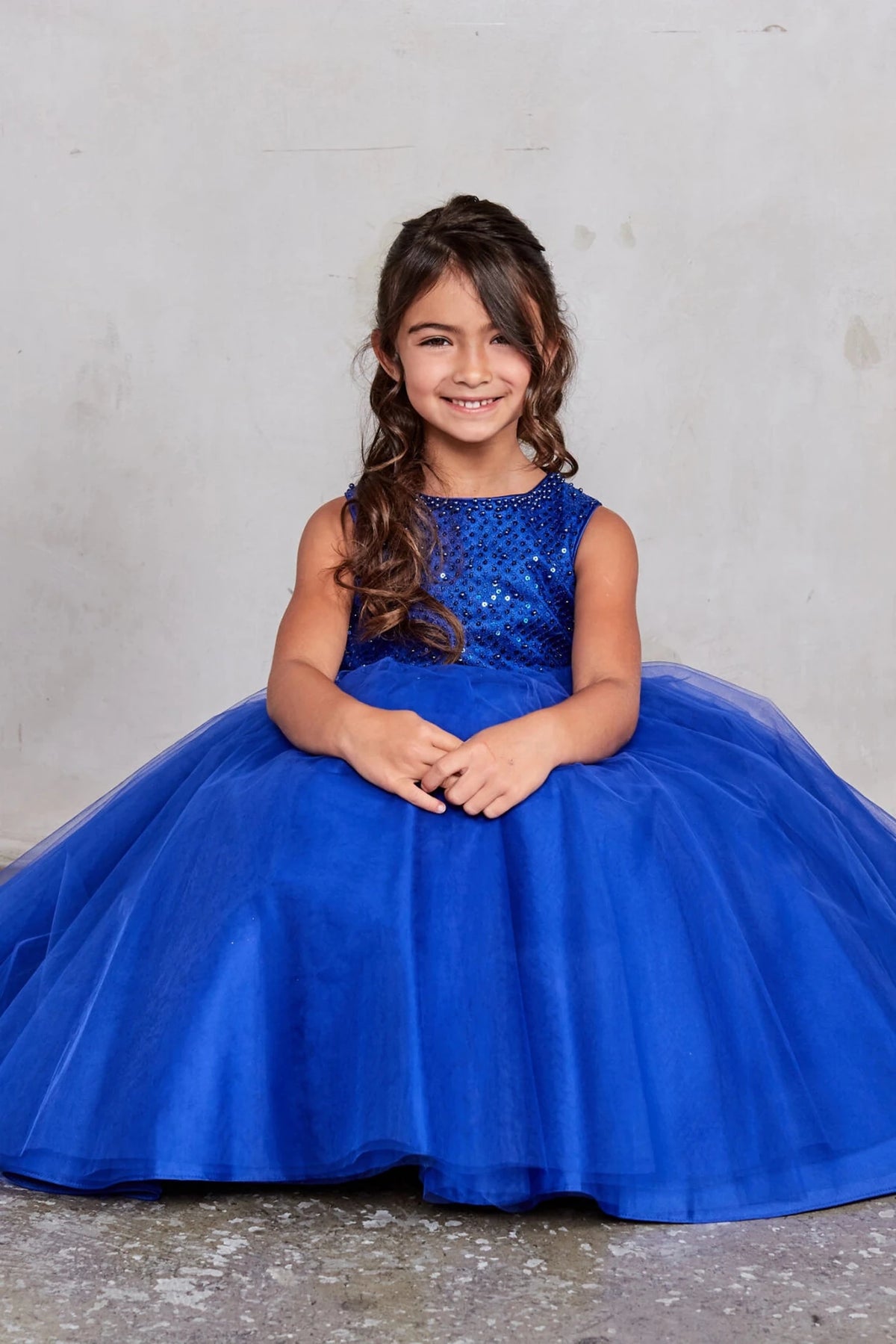 Full mesh skirt accents this royal blue flower girl dress.