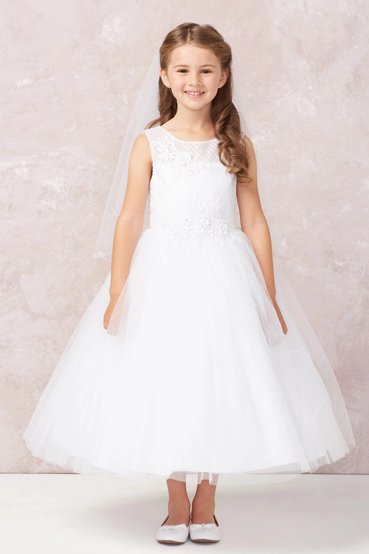 A view of a flower-trimmed waist on the white flower girl dress.