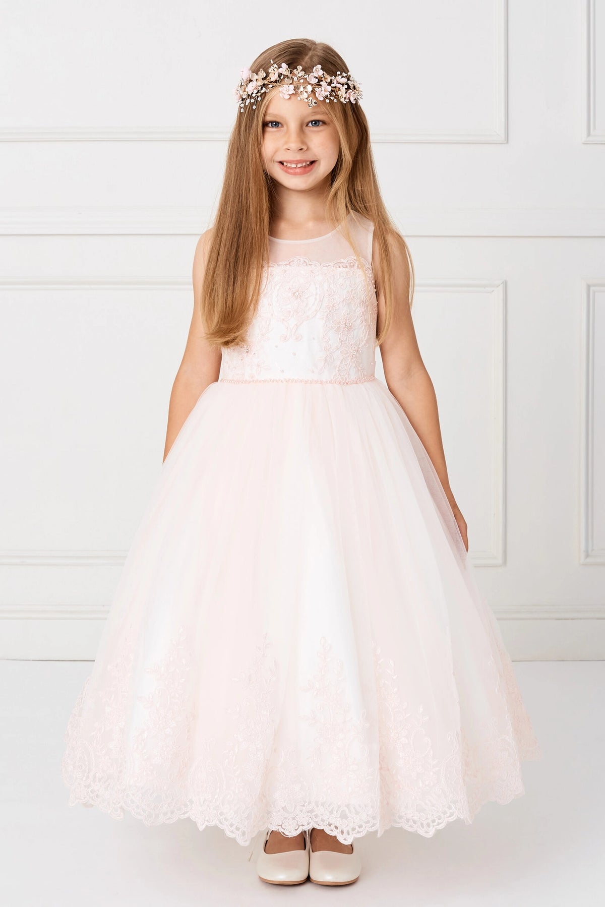 Blush flower girl dress with scalloped embroidery around the skirt edge.