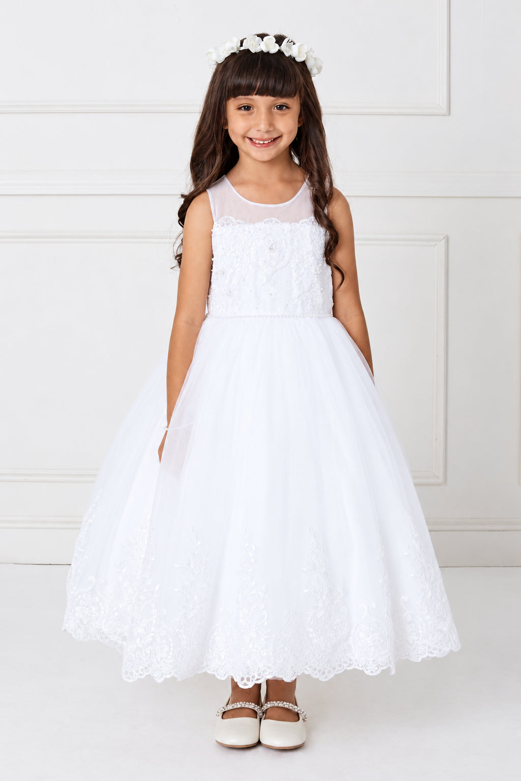 Sheer shoulders top the white flower girl dress's floral bodice.