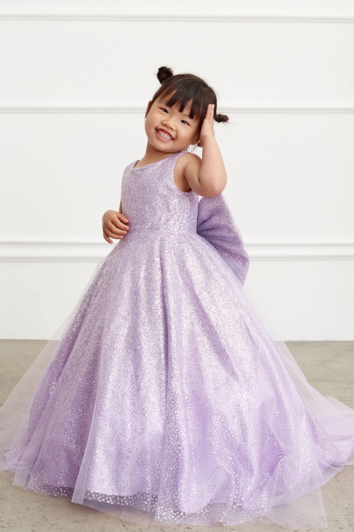 Lilac kids pageant dress featuring a full glitter skirt.