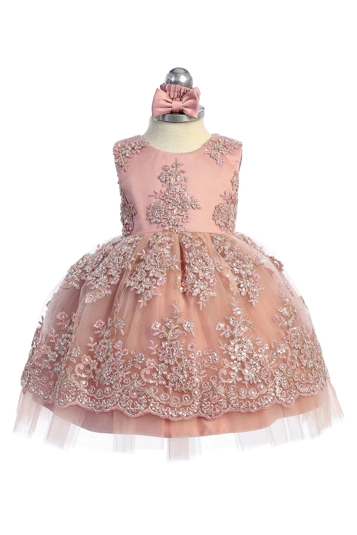 Ornate skirt border is visible on the blush flower girl dress.