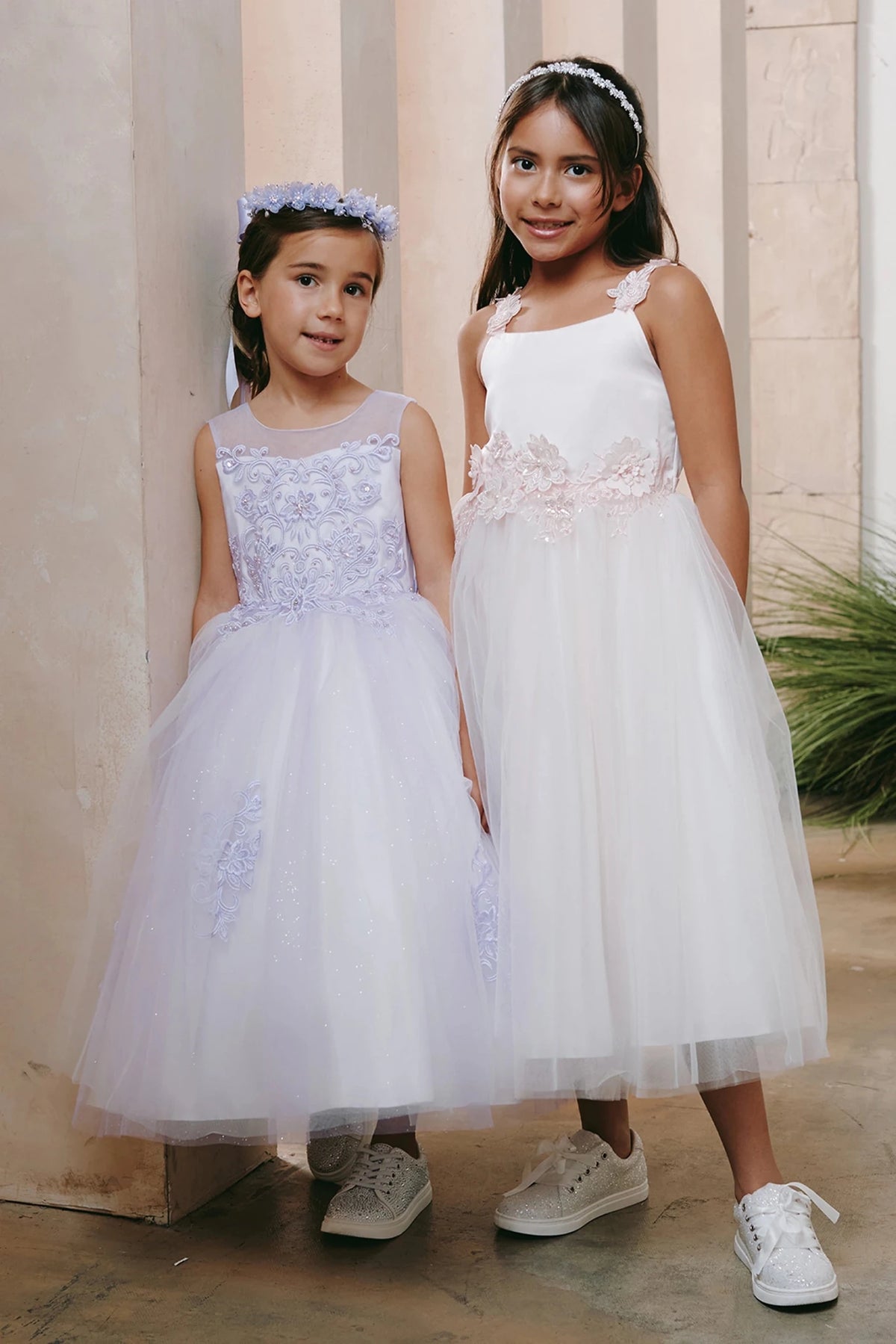 White and lilac flower girl dresses with floral lace bodices.