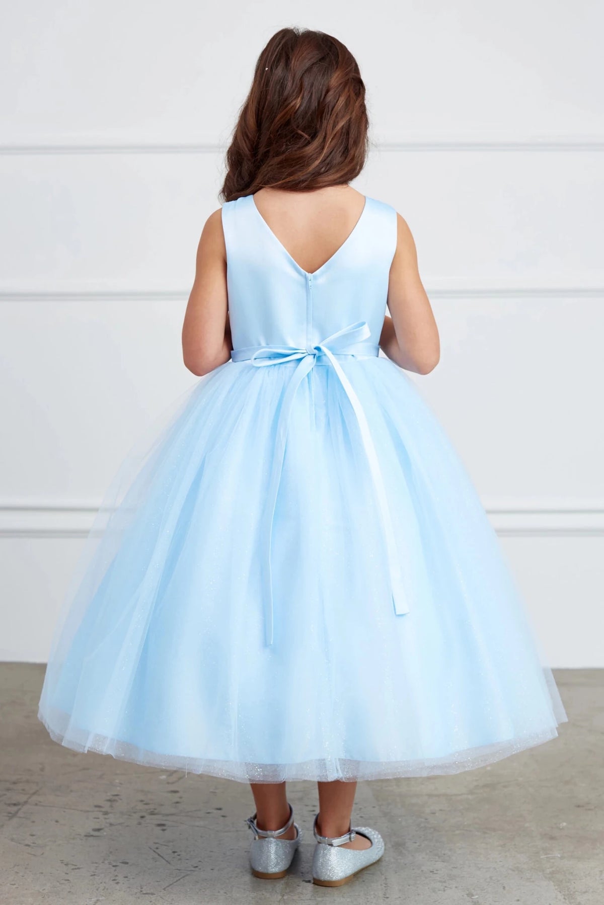 This sky blue flower girl dress displays a satin back bow.