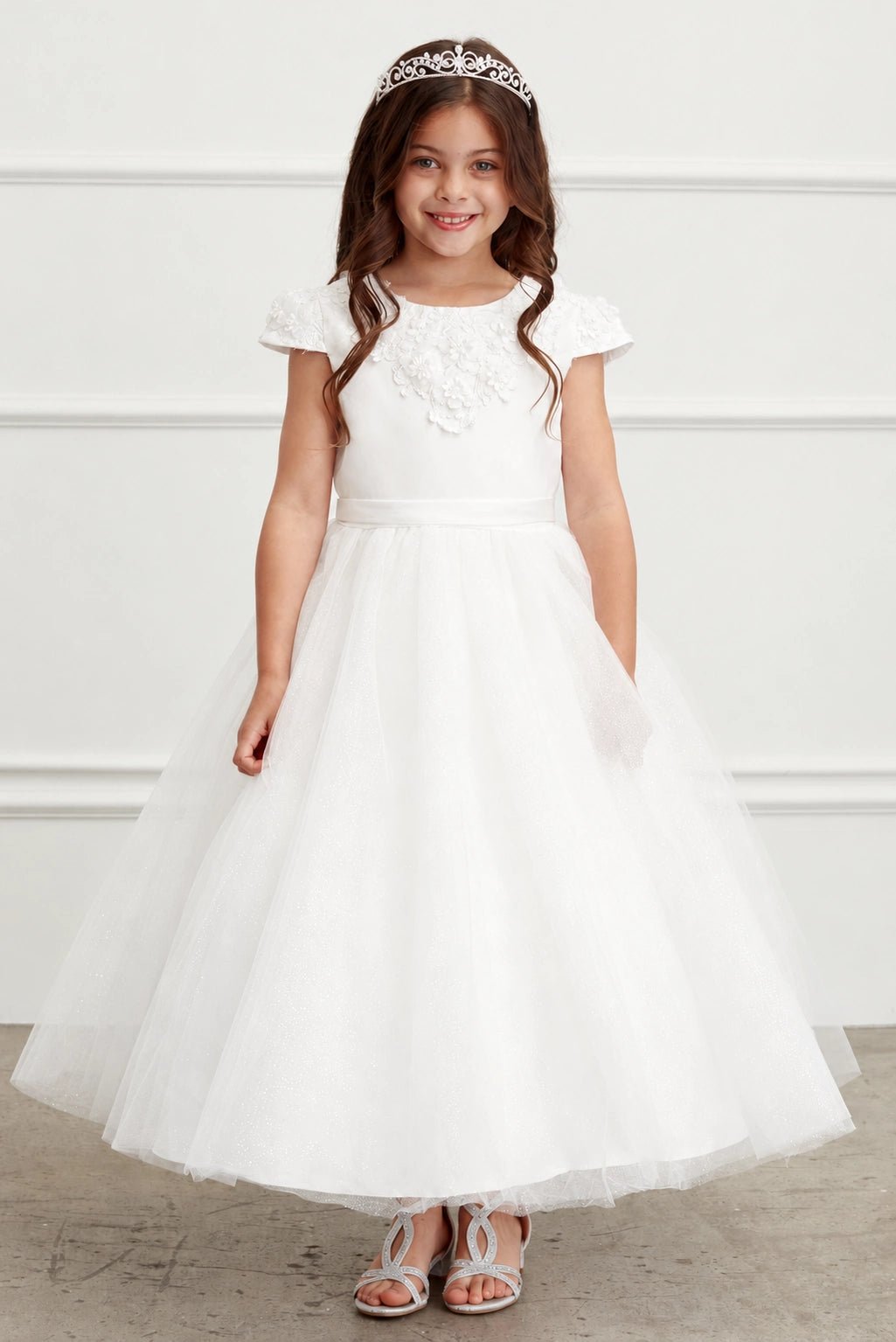 Full tulle skirt accents the off-white flower girl dress.