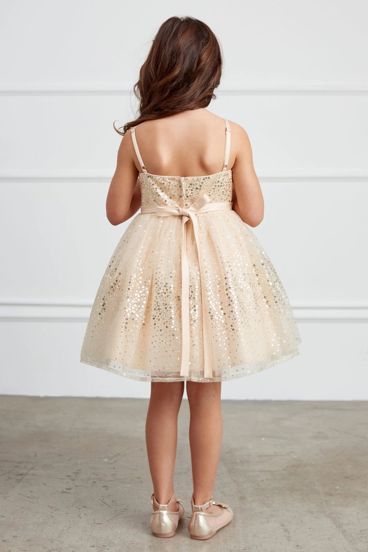 The Gold kids pageant dress has a tied sash across the back waist.