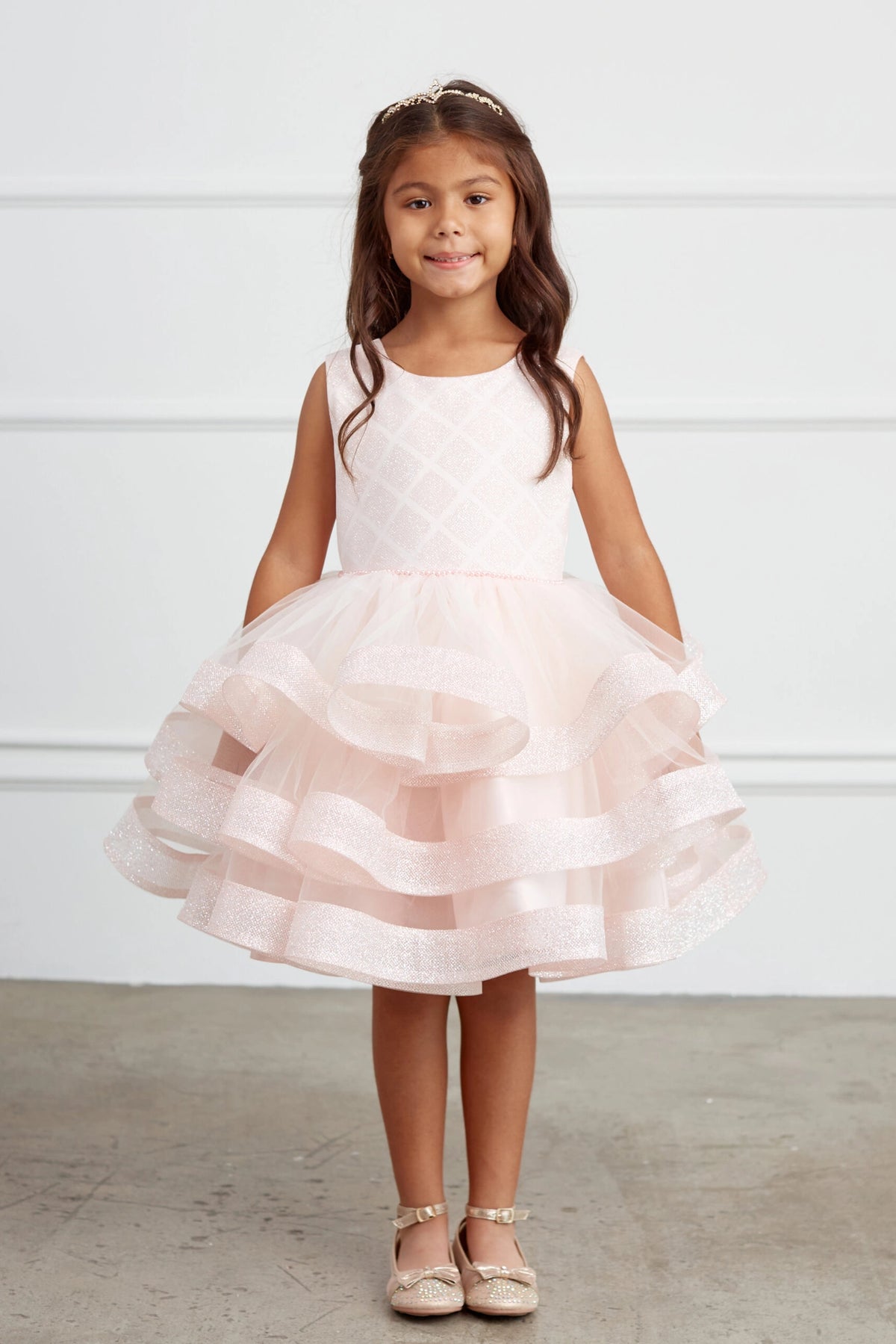 Visible details on the Blush kids pageant dress include a short tiered mesh skirt.