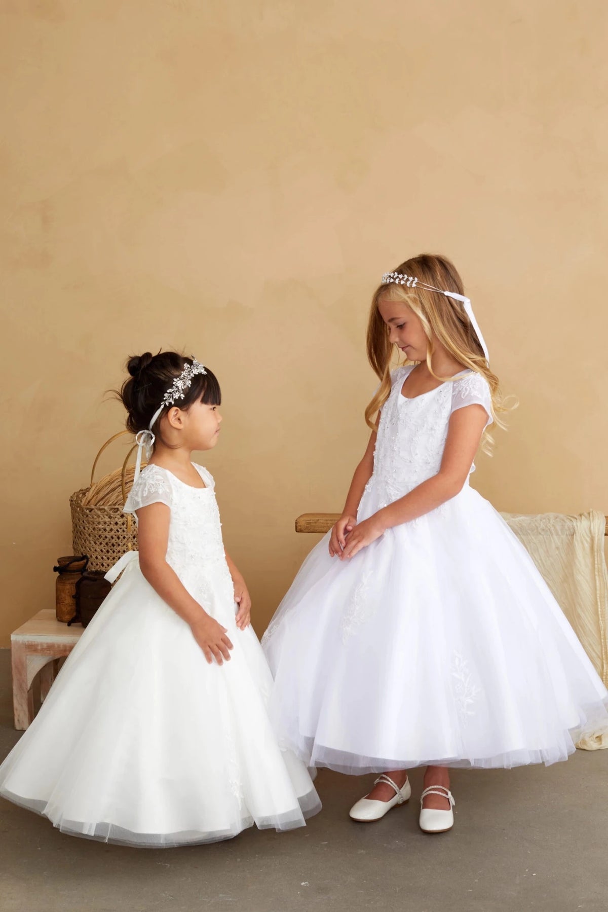 Full tulle skirts on a white flower girl dress.