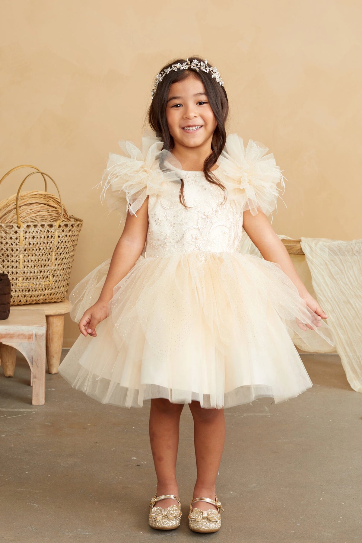 Champagne kids pageant dress featuring feather-trimmed flutter sleeves.