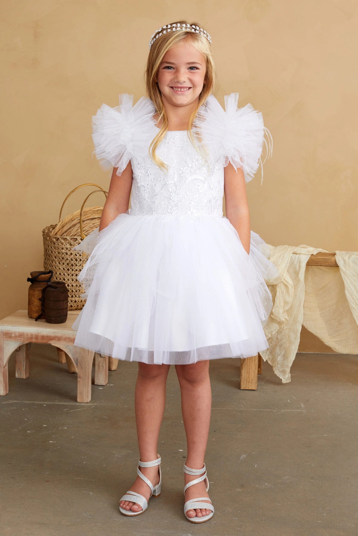 White kids pageant dress featuring feather-trimmed flutter sleeves.