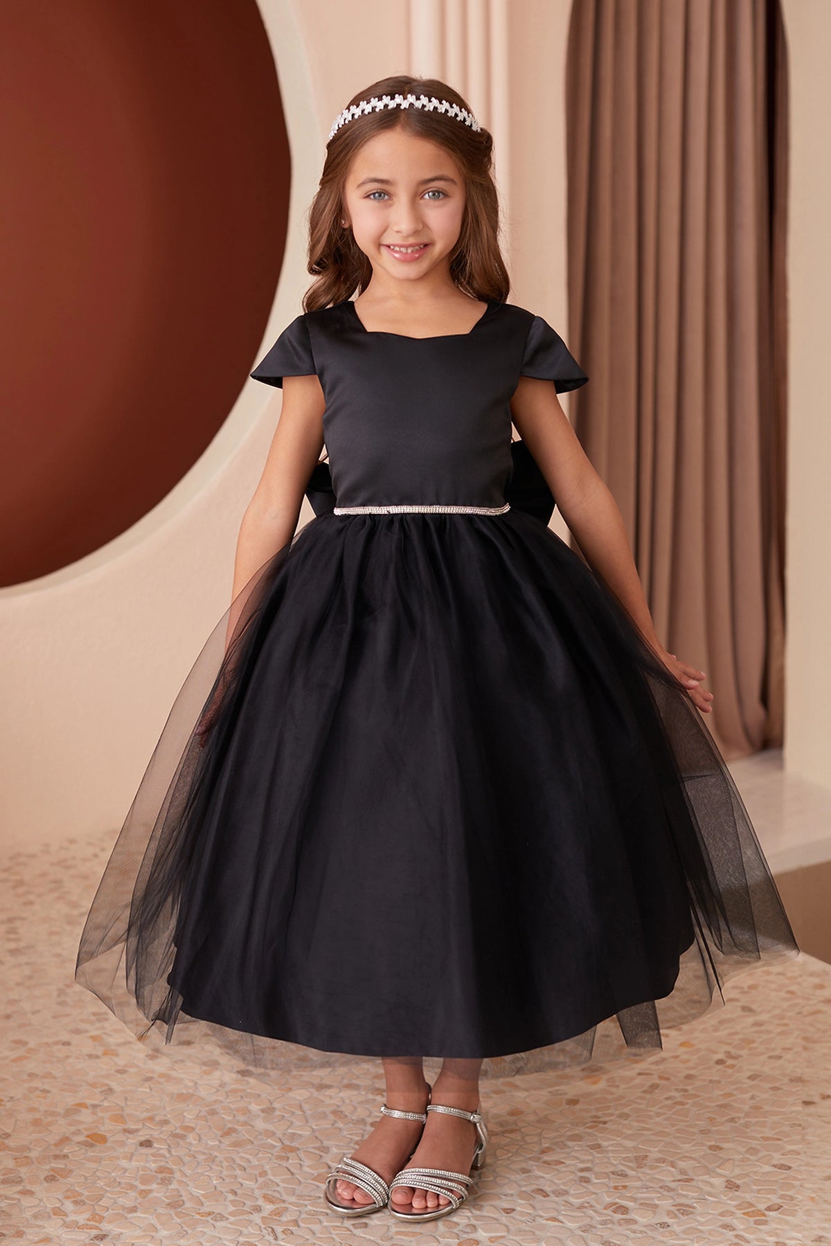Black kids pageant dress featuring a square satin neckline and tulle skirt.