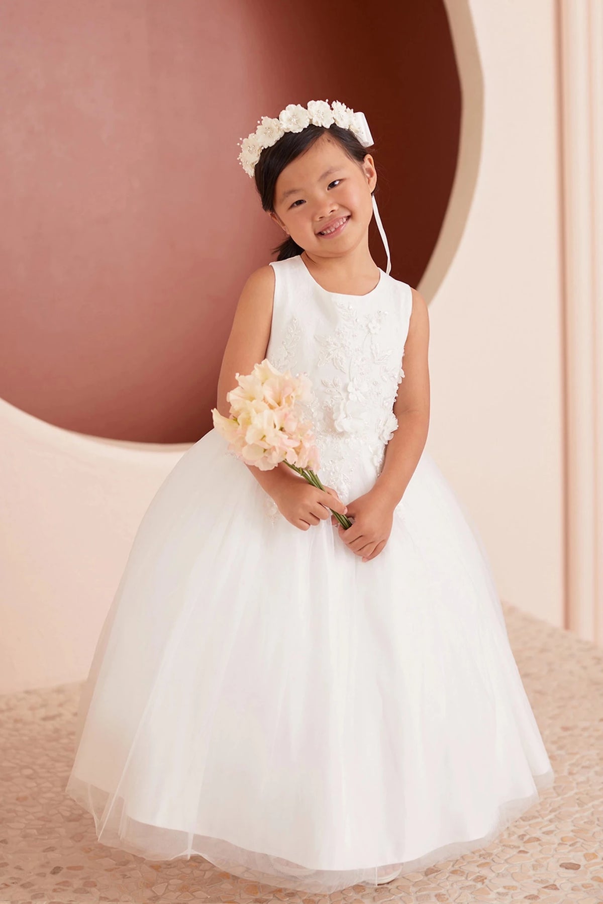 Side view of the ivory 3d floral lace with a bow back flower girl dress.