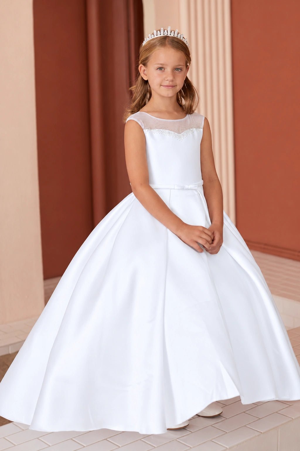 Sparkling trim follows the white flower girl dress's straight bodice edge.