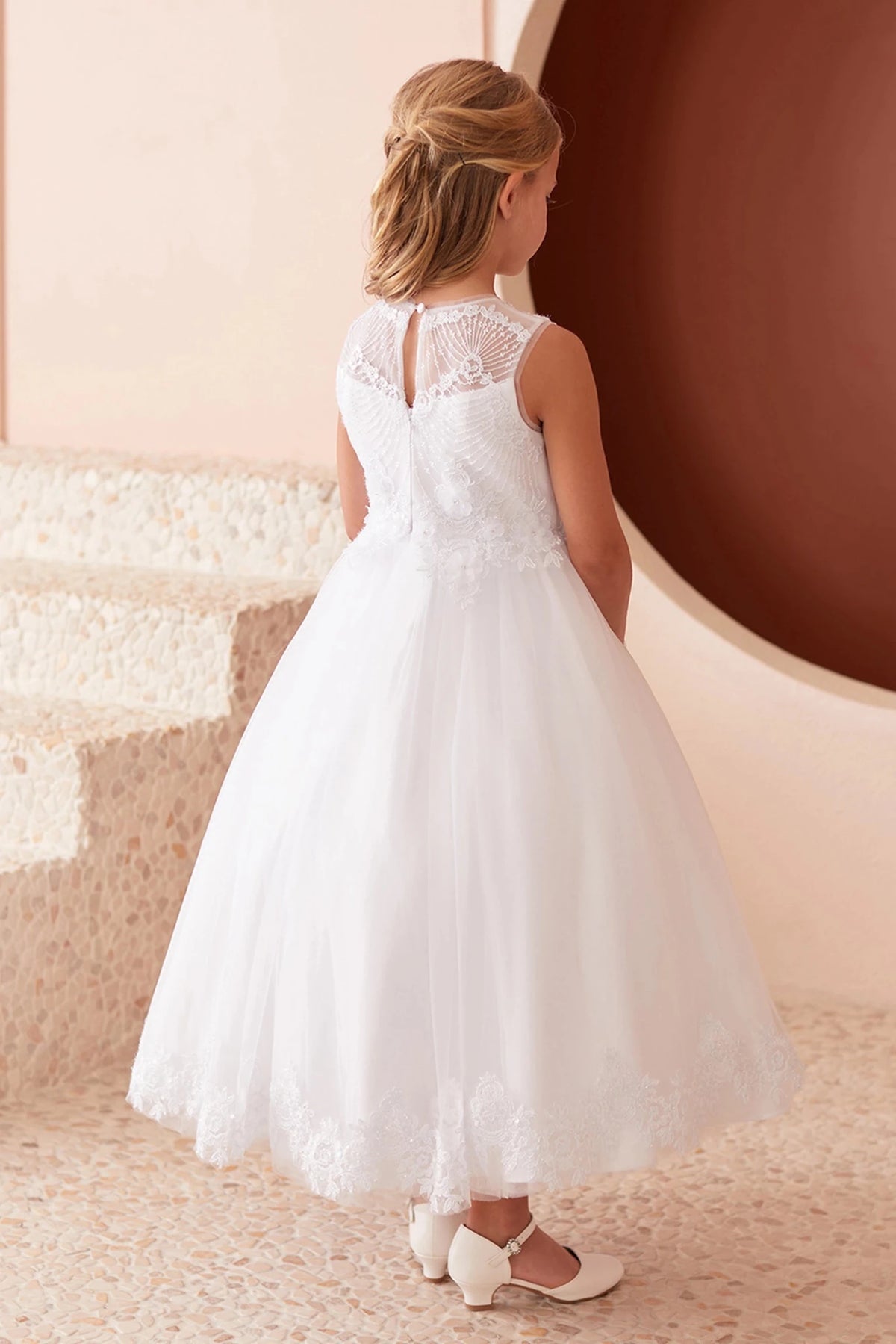 Lace-trimmed skirt hem shown on the white flower girl dress.