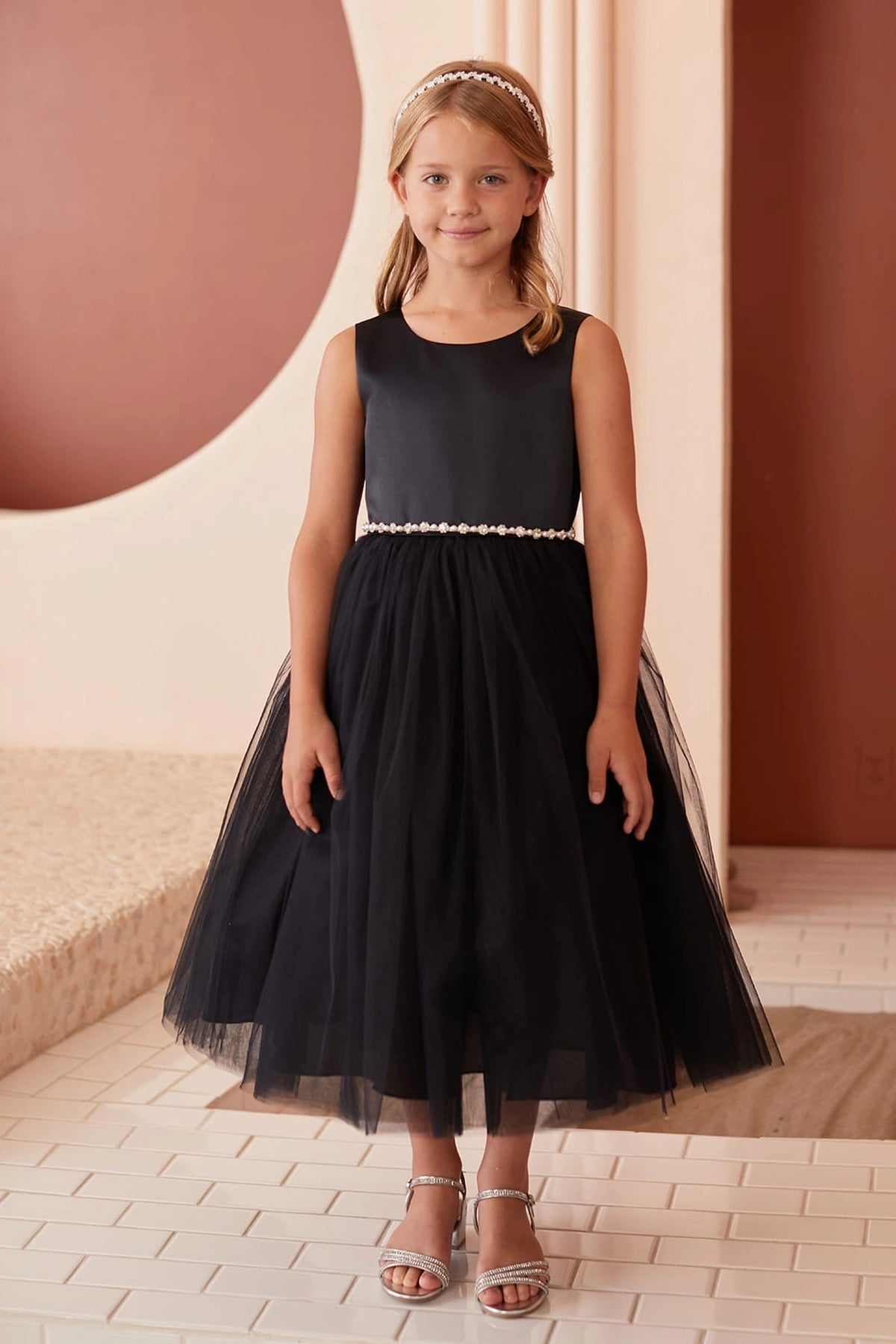 Black kids pageant dress featuring a pearl-accented waist and tulle skirt.