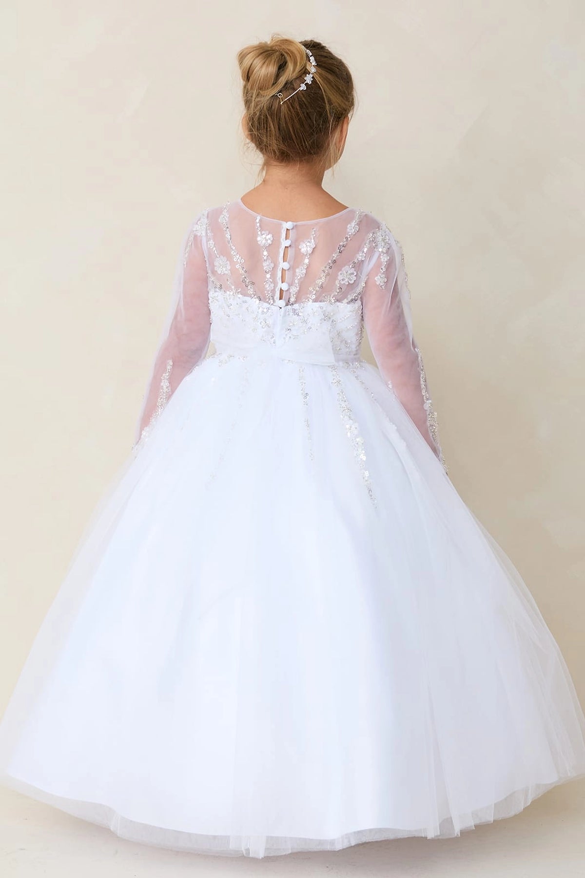 Visible on the white flower girl dress: a full tulle back skirt.