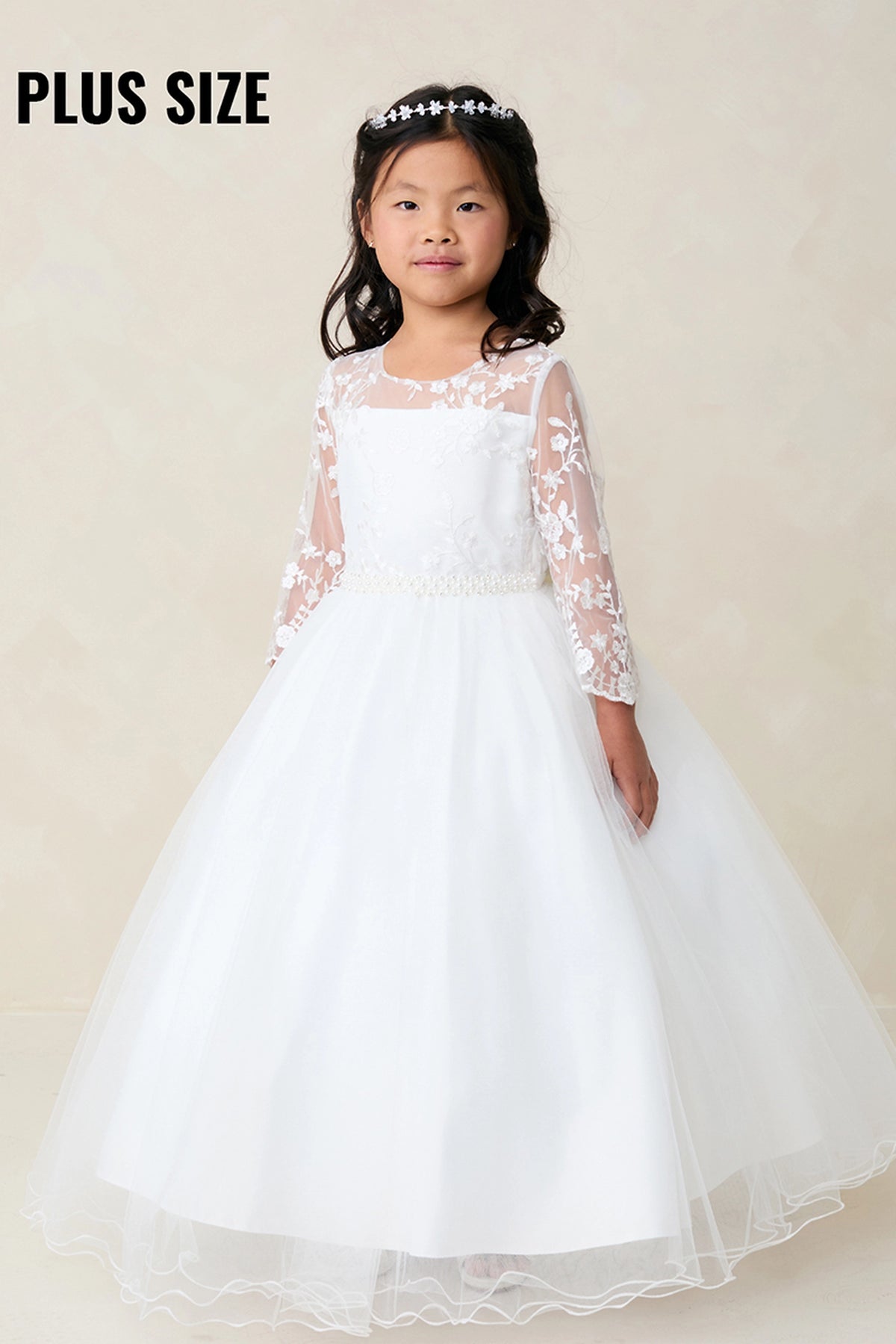 On this white flower girl dress, lace-trimmed sleeves are visible.