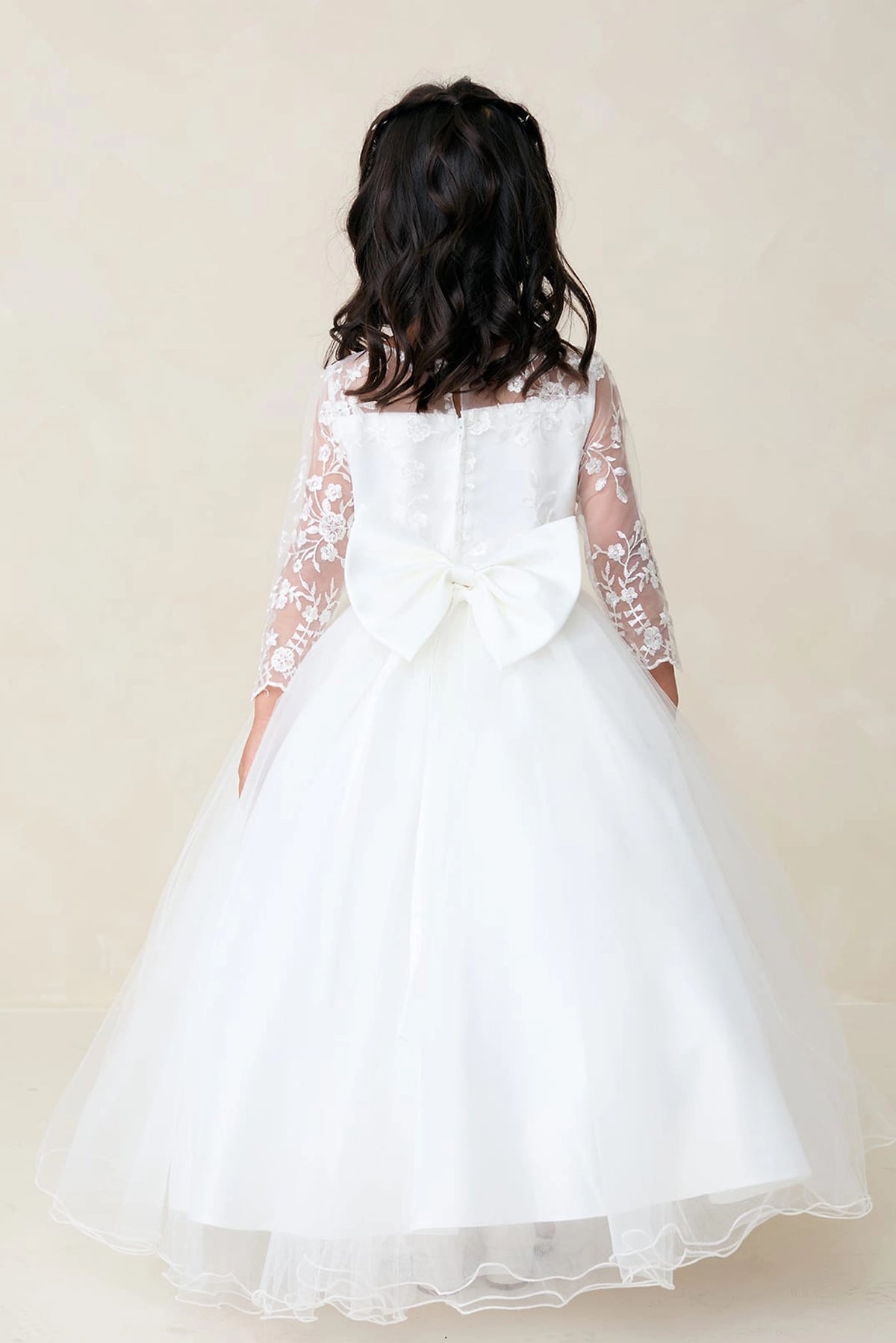 Full tulle back skirt is visible on the white flower girl dress.