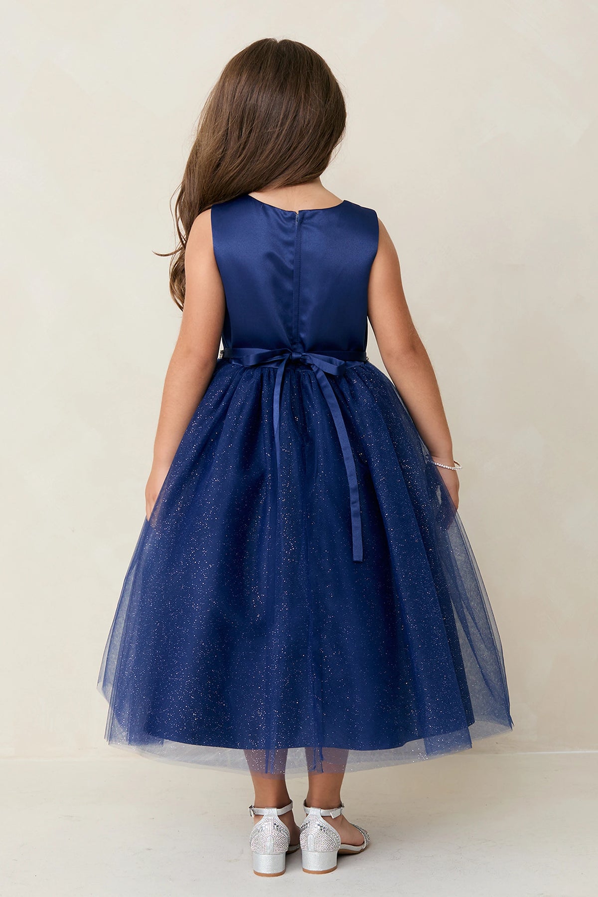 The Navy Blue kids pageant dress has a tied sash across the back waist.