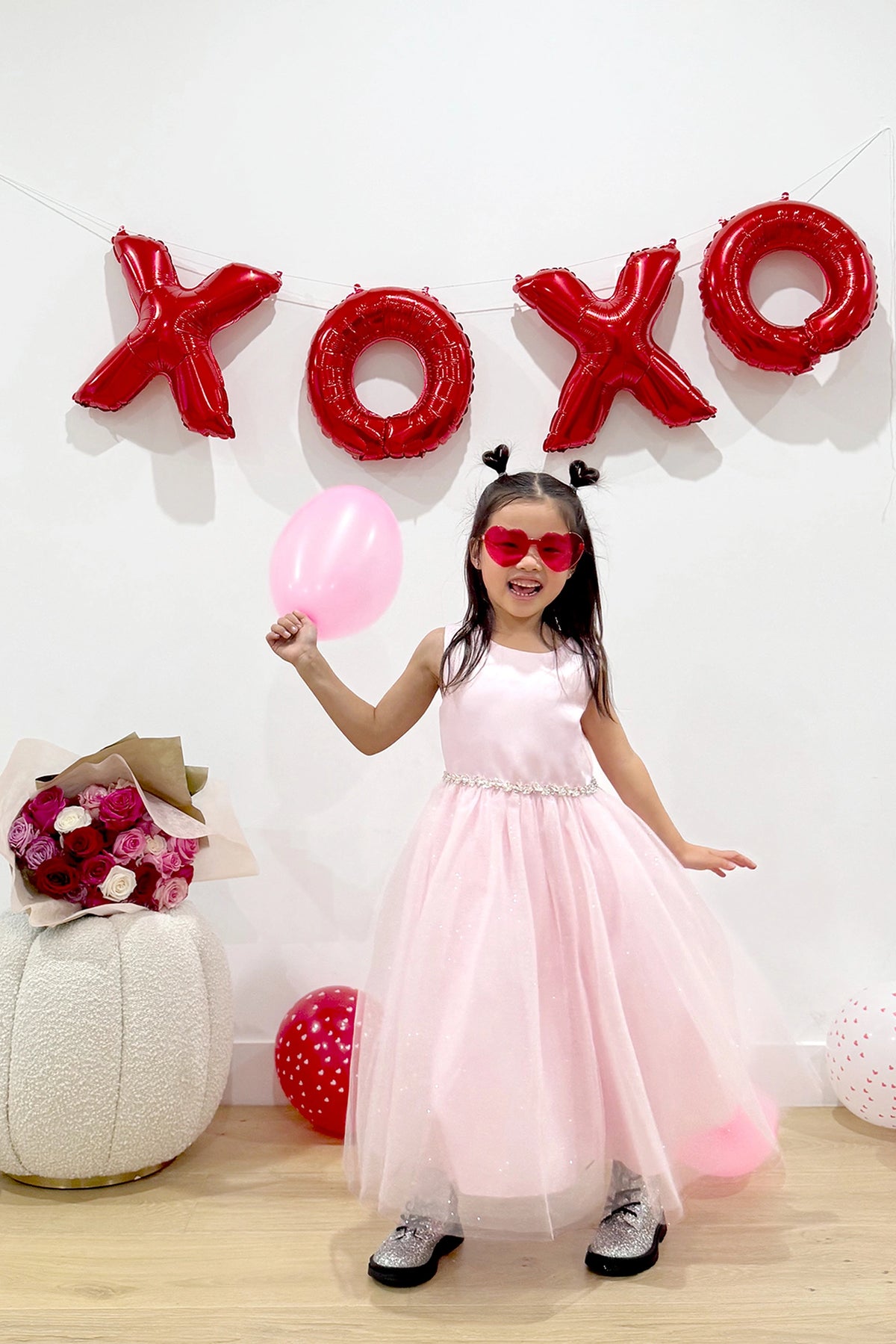 Pink kids pageant dress featuring a satin bodice and sparkling tulle skirt.