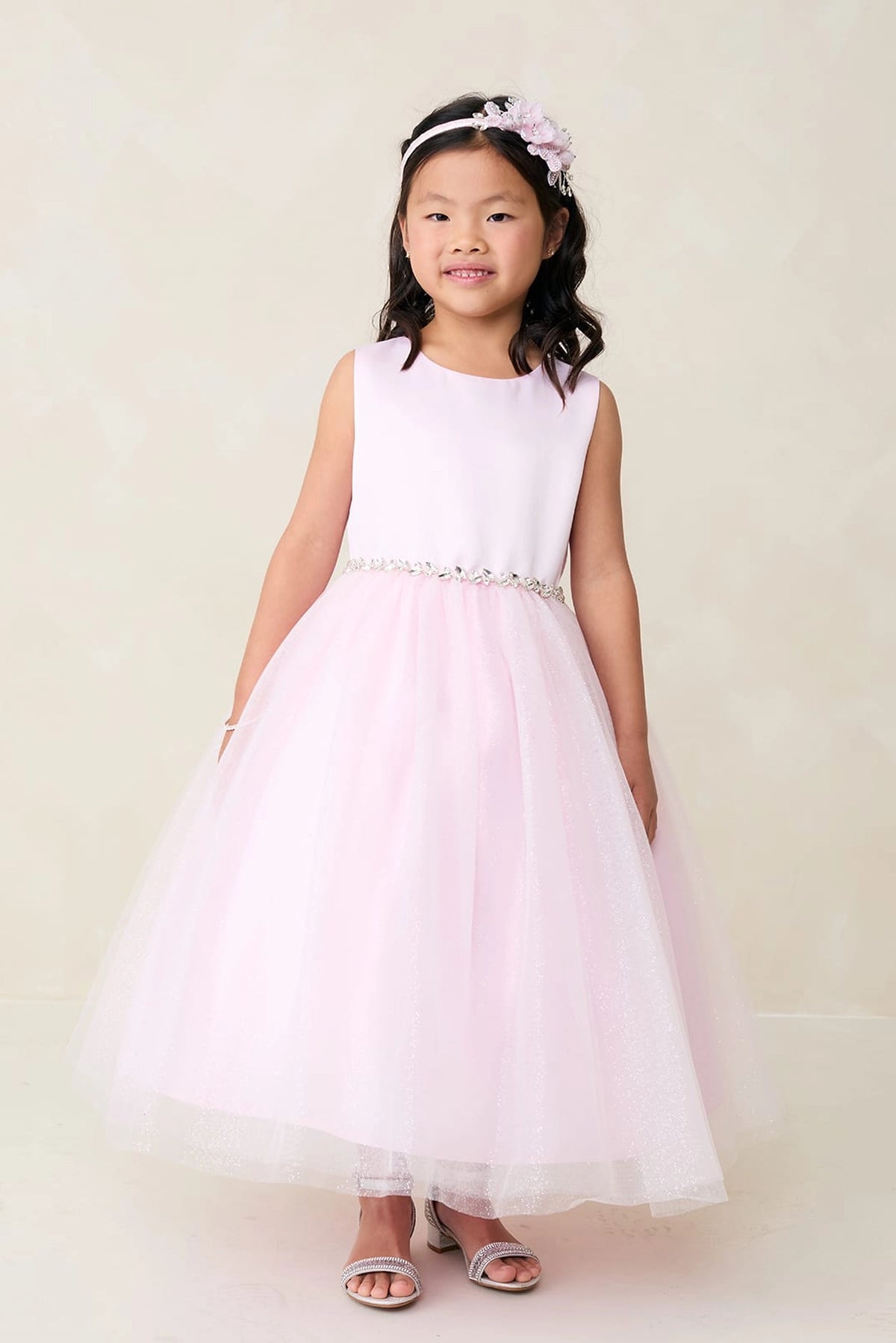 The Pink kids pageant dress has a satin bodice and sparkling tulle skirt.