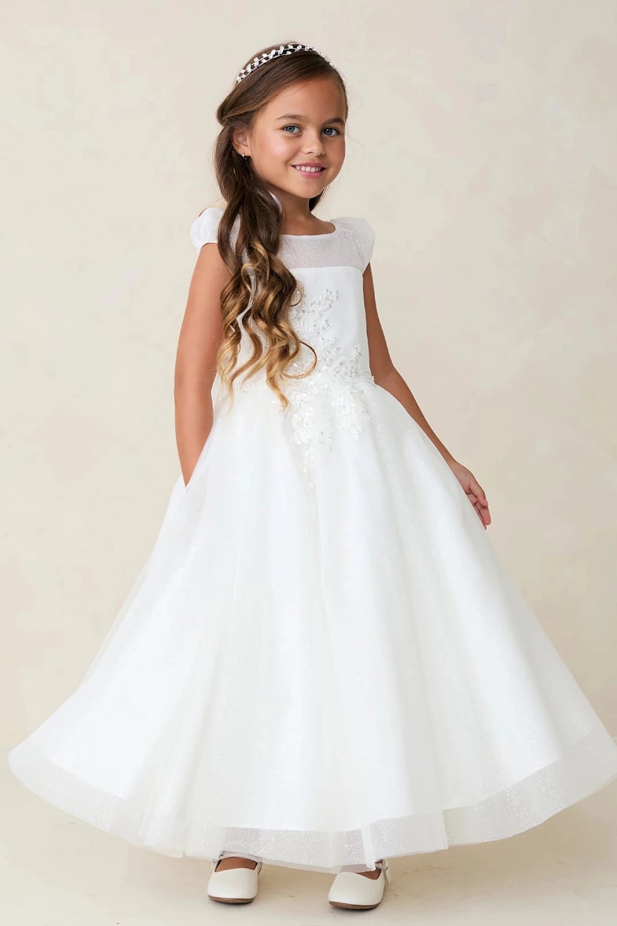 A view of an off-shoulder lace band on the off-white flower girl dress.