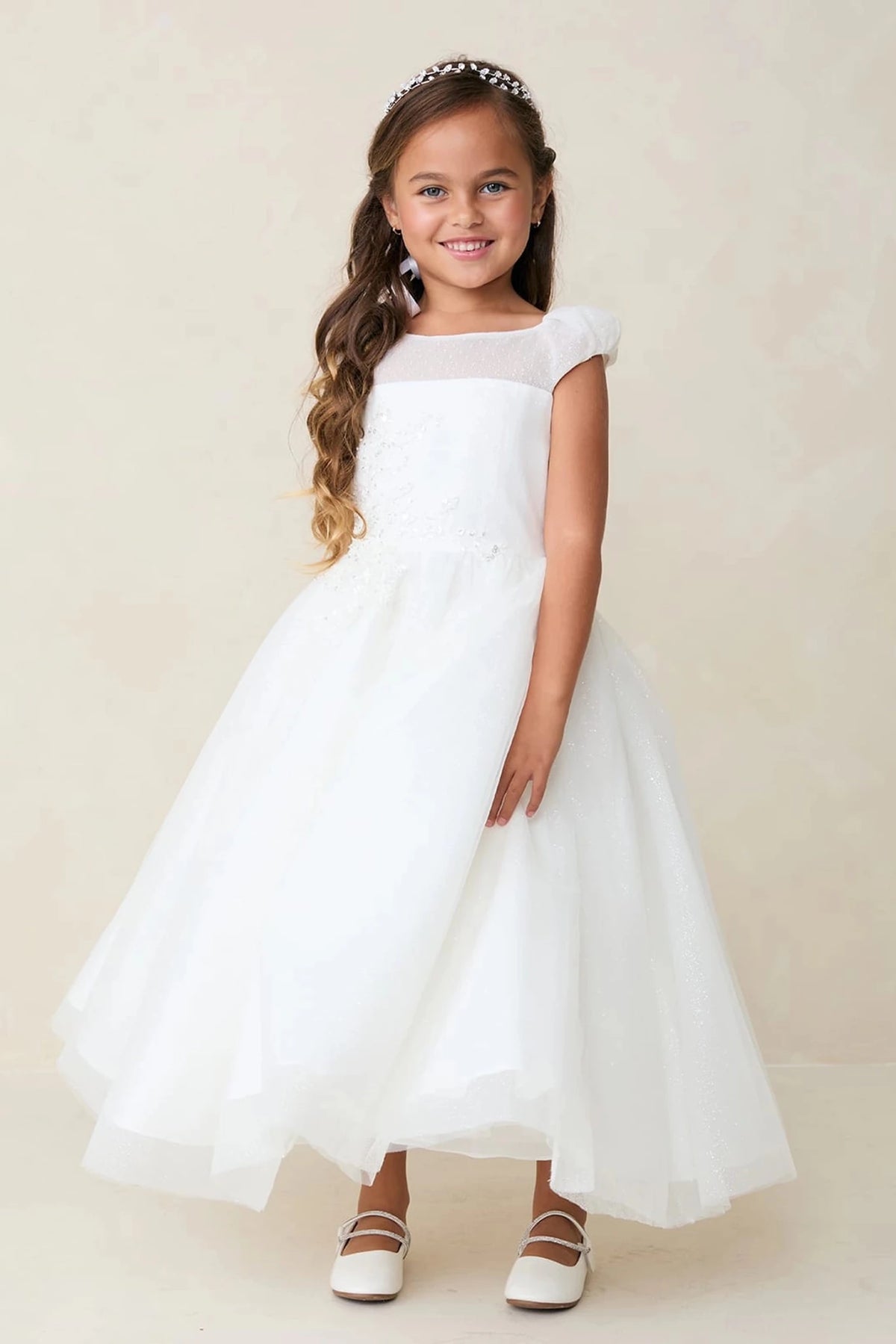 With a beaded lace bodice, an off-white flower girl dress.
