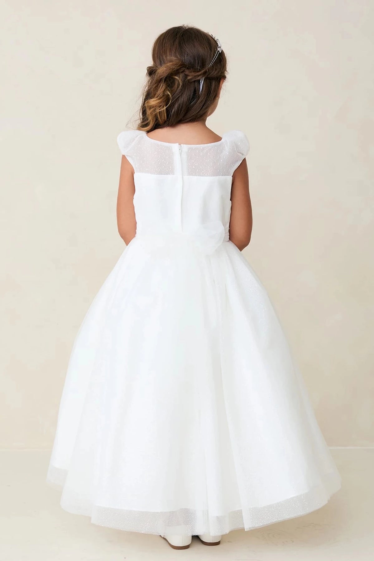 Visible on the off-white flower girl dress: a sheer back neckline.
