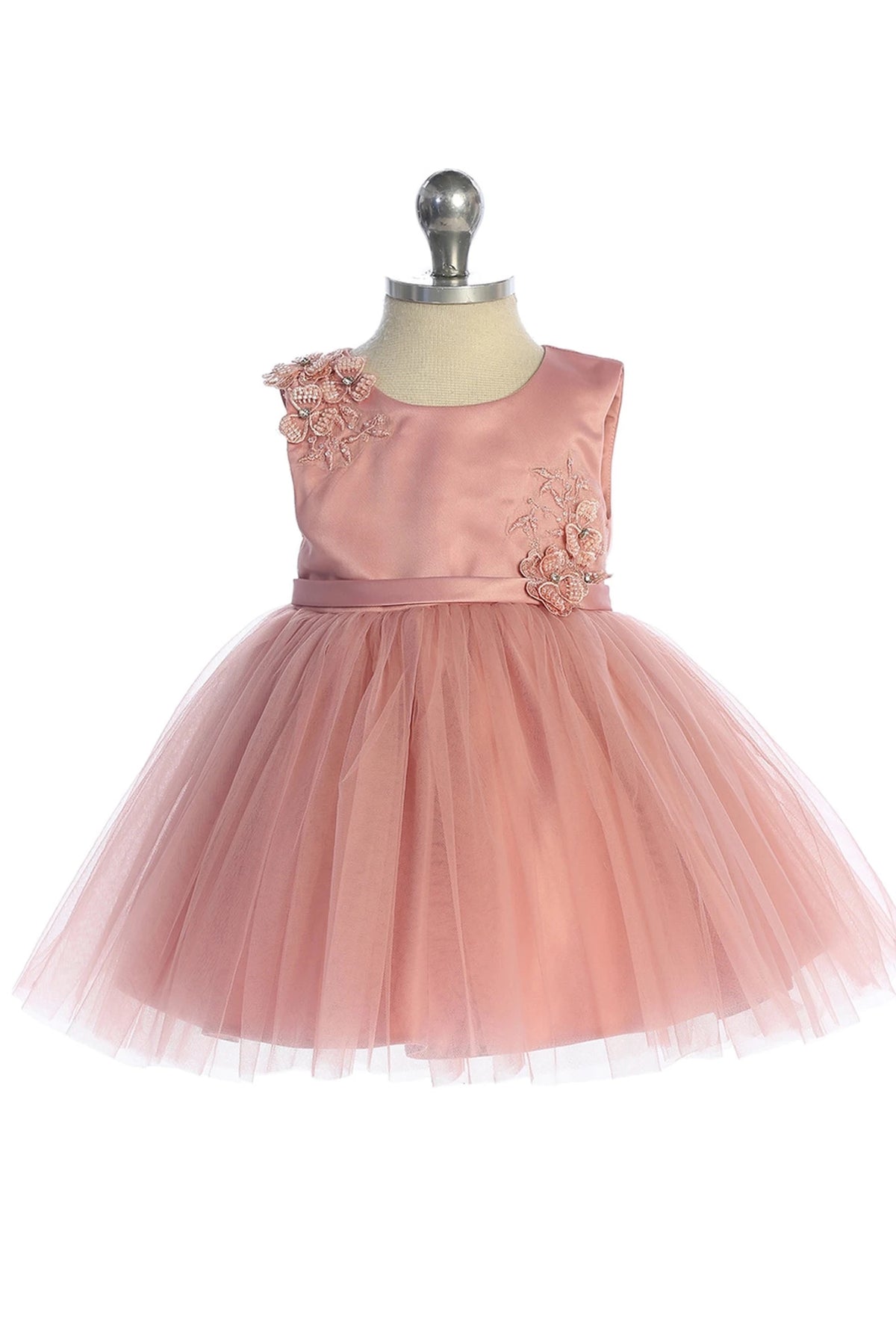 In view: a flower shoulder accent of a dusty rose flower girl dress.